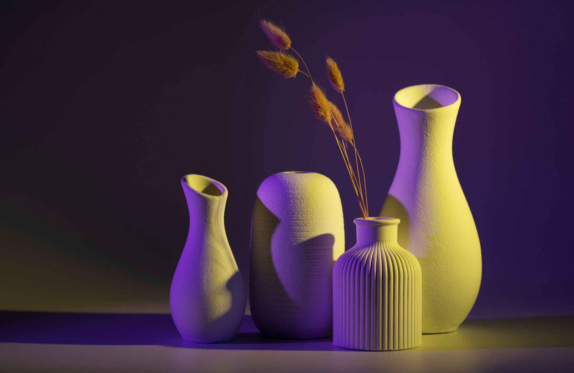 Set of colorful vases with a dark purple background